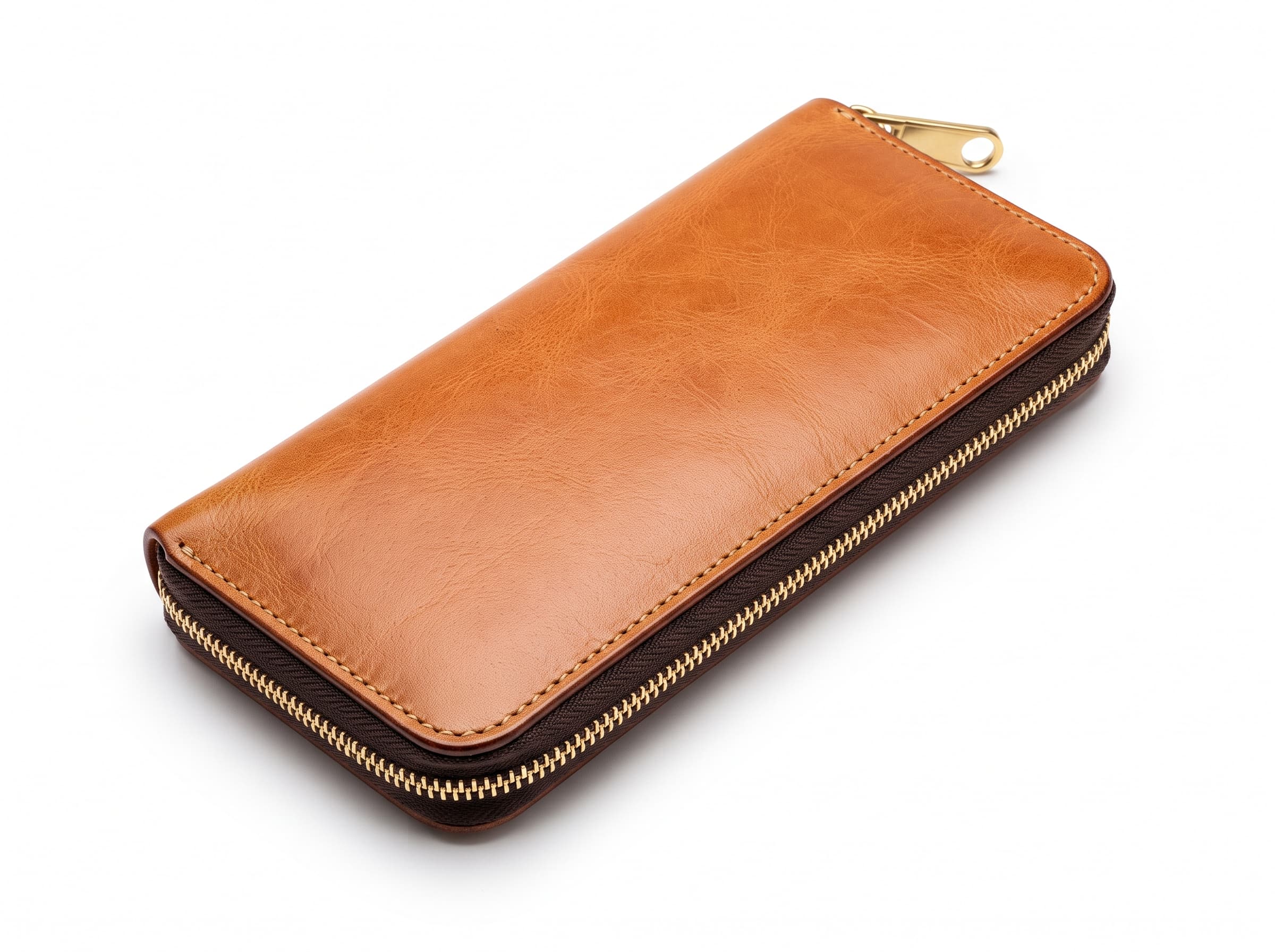 Long tan leather zip-around wallet with a brass zip running the full perimeter